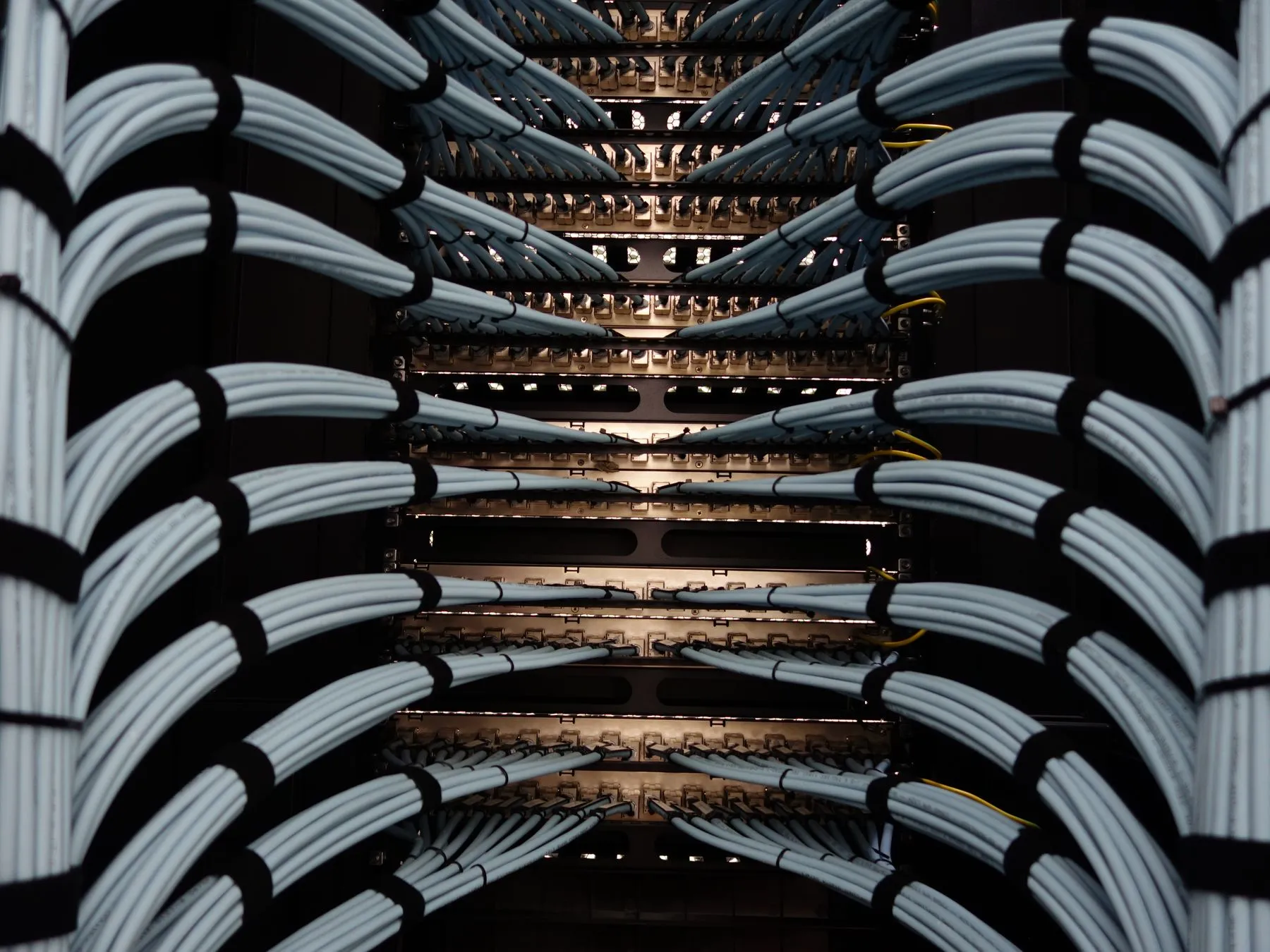 Organised bundles of network cables in a rack