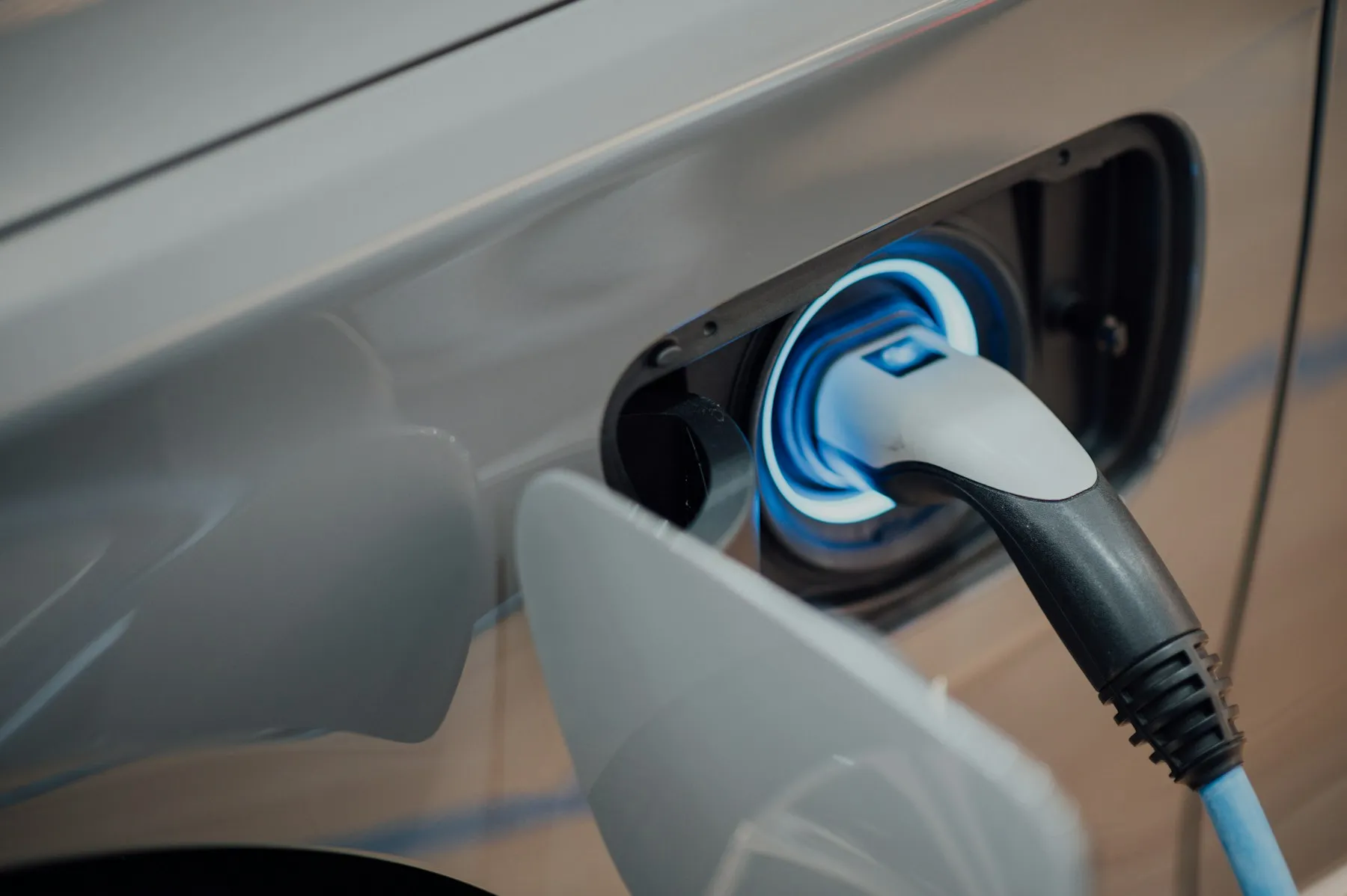 Electric vehicle plugged in to charge