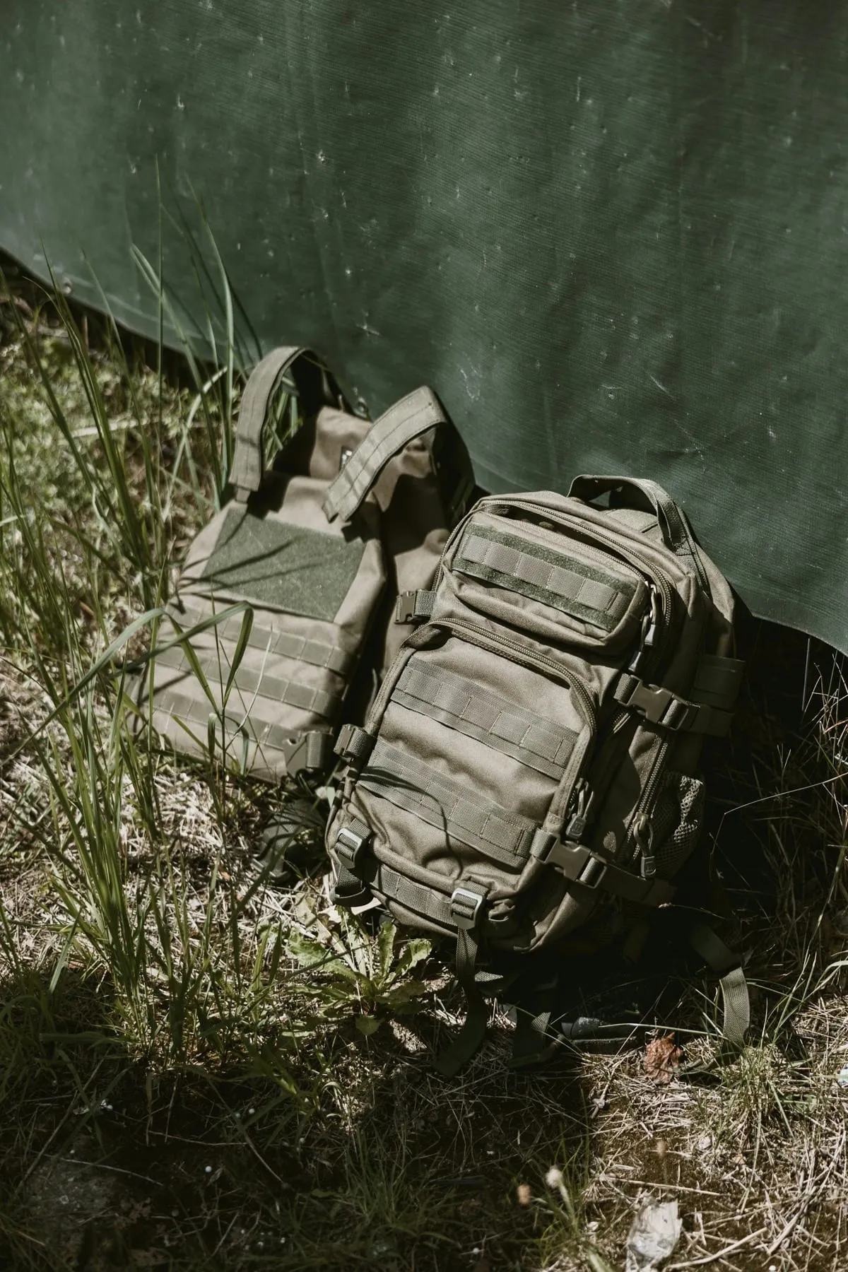 Tactical backpack resting on grass